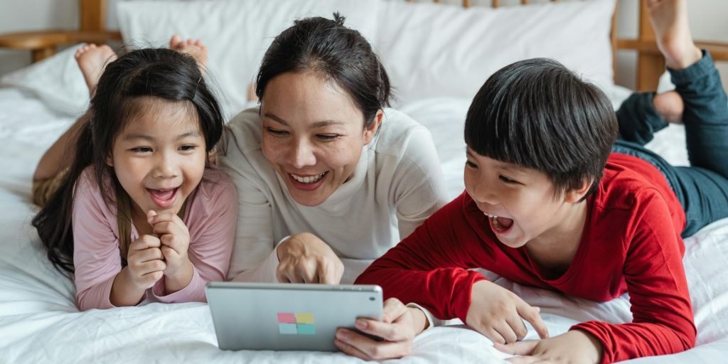 mom playing educational games with her kids on their tablet